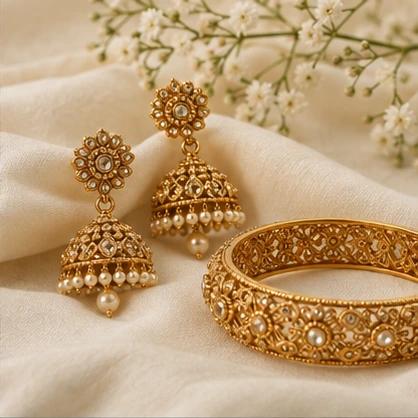 Fine gold jewellery styled on an ivory surface